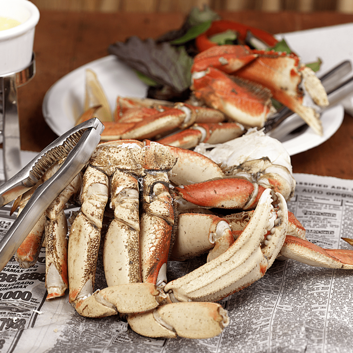 Fresh Dungeness Crab Sections displayed on a clean surface.