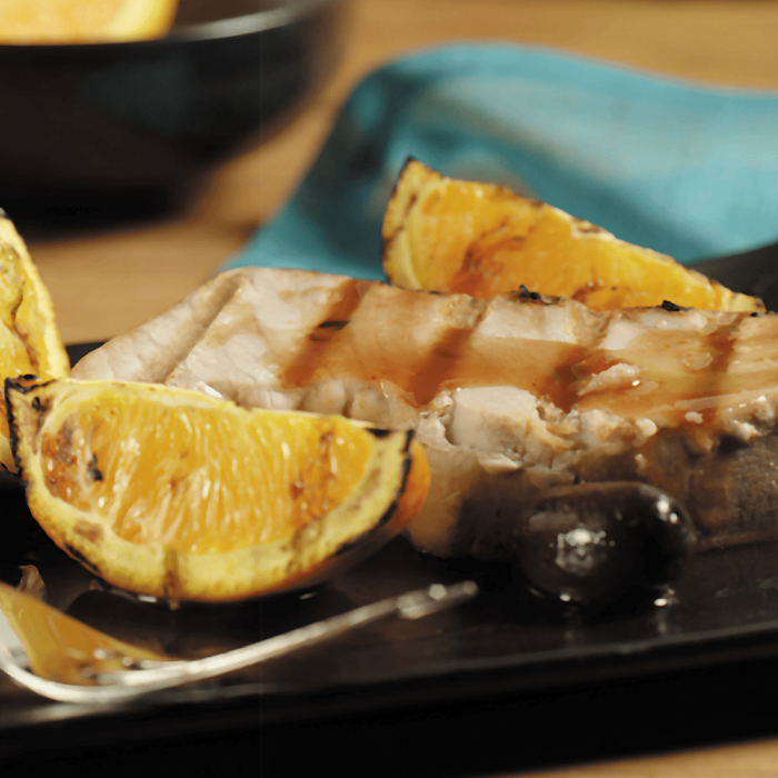 Fresh tuna steaks displayed on a clean surface.