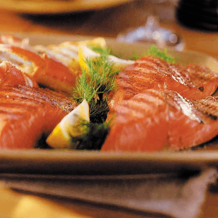 A variety pack of wild salmon products including canned salmon, smoked salmon, and salmon jerky.