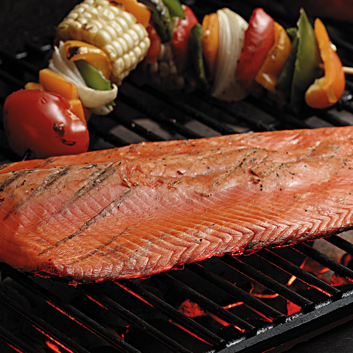 Two whole sides of smoked salmon displayed on a simple background.